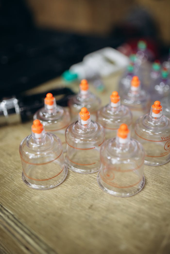 A close-up view of cupping therapy equipment on a wooden table, used for holistic treatment and wellness.